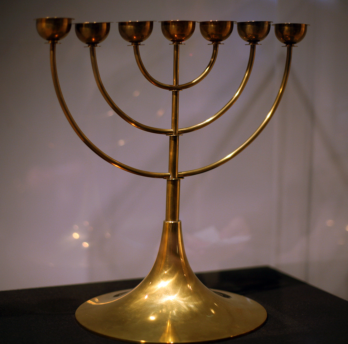 Brass seven-branch candelabrum (menorah) in Bauhaus style, showing the traditional form with central stem and three branches on each side