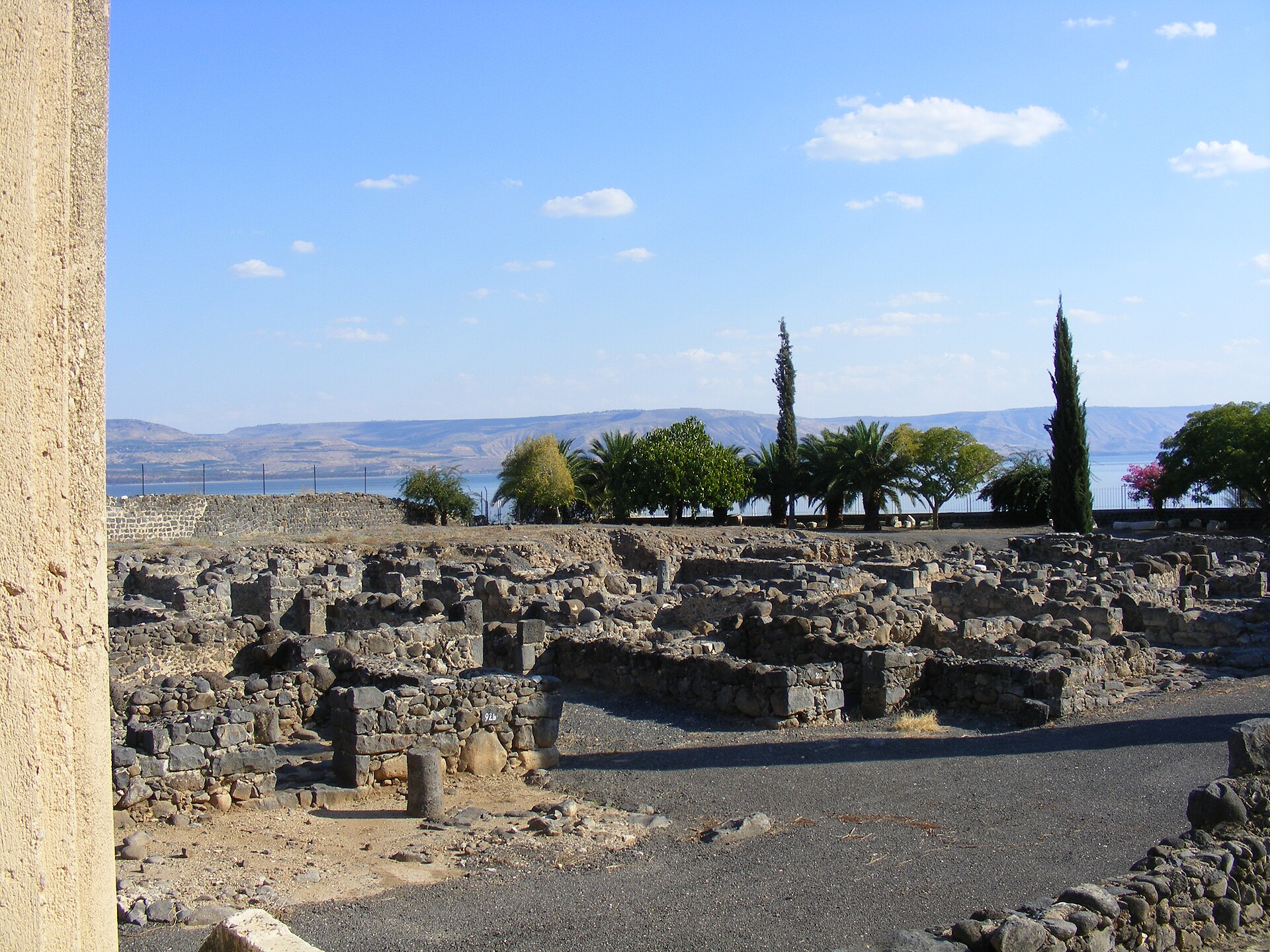 Ruins of the white limestone synagogue at Capernaum showing ancient stone foundations, columns, and architectural fragments of an early Jewish prayer structure on the shore of the Sea of Galilee