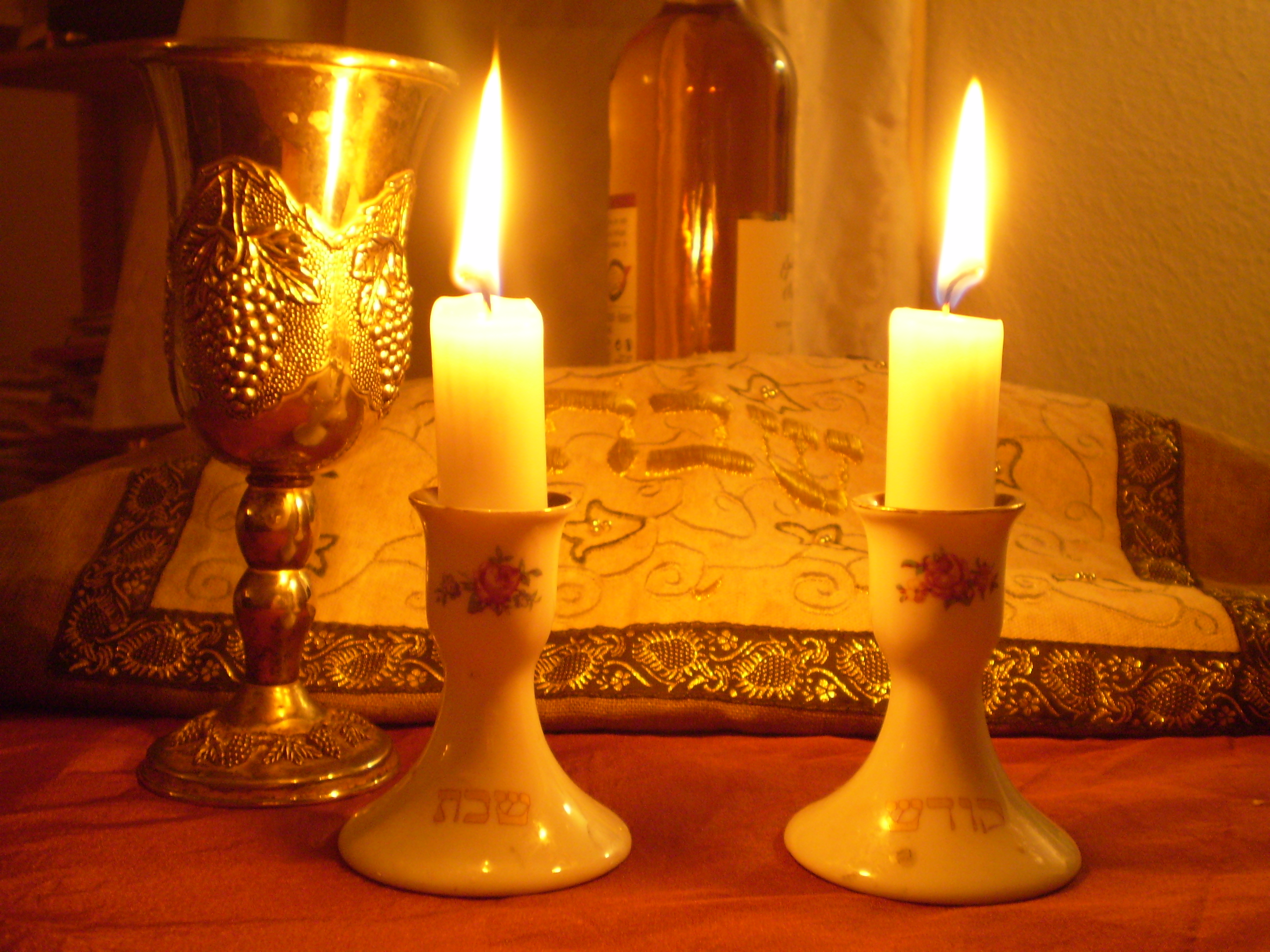 Shabbat candles and kiddush cups arranged for the weekly Jewish Sabbath blessing ritual